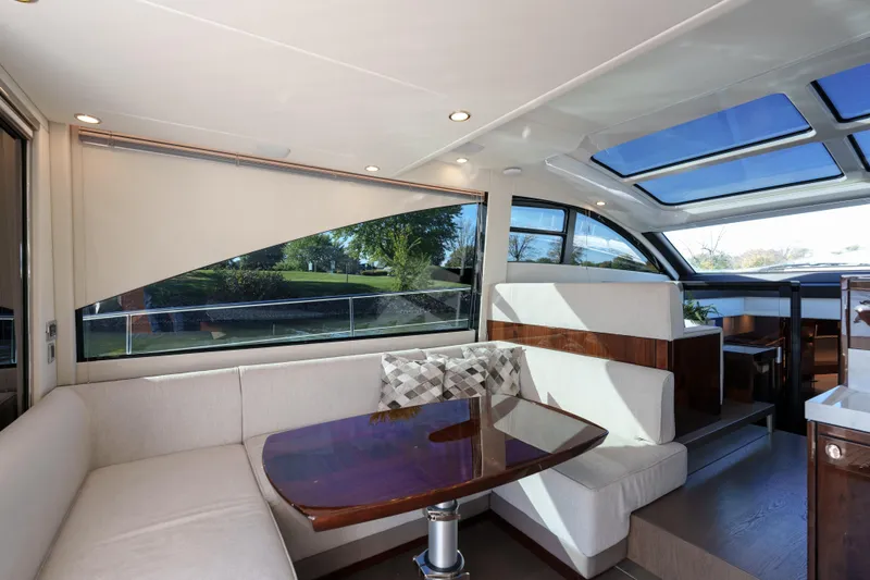  Yacht Photos Pics Luxurious interior of 2023 Fairline Targa 50 yacht with elegant seating and panoramic windows.