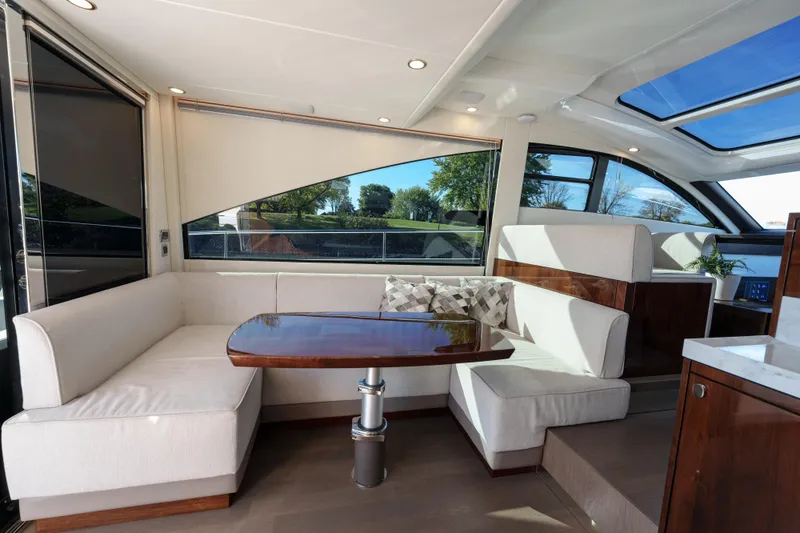  Yacht Photos Pics Luxurious interior of 2023 Fairline Targa 50 yacht with elegant seating and panoramic windows.
