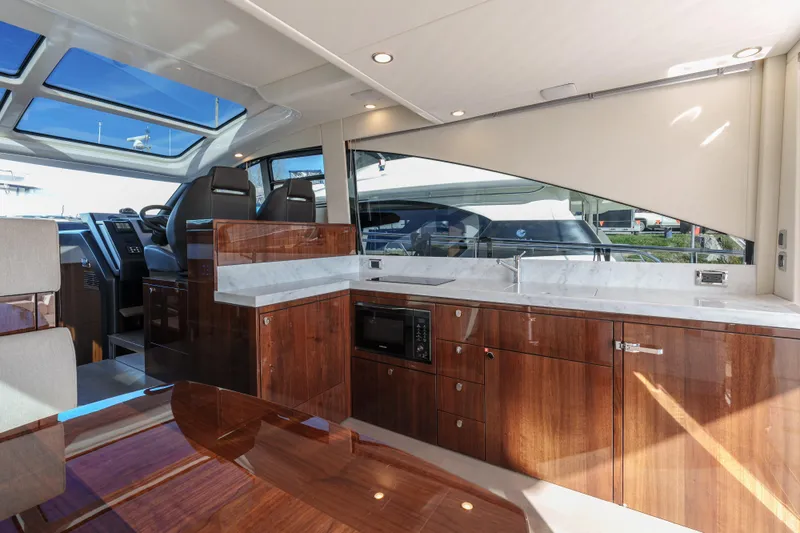  Yacht Photos Pics Luxurious interior of 2023 Fairline Targa 50 yacht with modern kitchen and seating area.