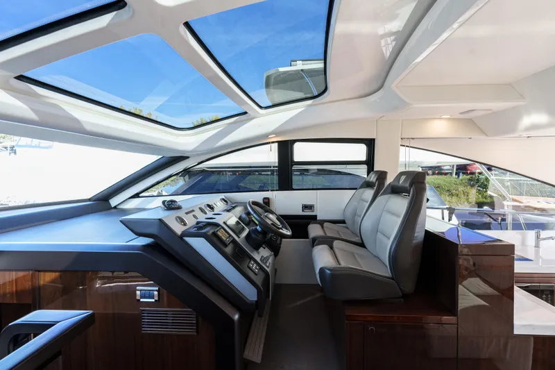  Yacht Photos Pics Interior of 2023 Fairline Targa 50 yacht, featuring sleek helm and luxurious seating.