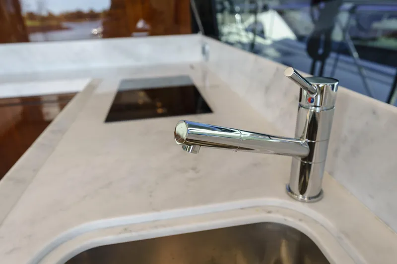  Yacht Photos Pics Modern kitchen faucet on Fairline Targa 50 yacht, 2023 model, with sleek marble countertop.