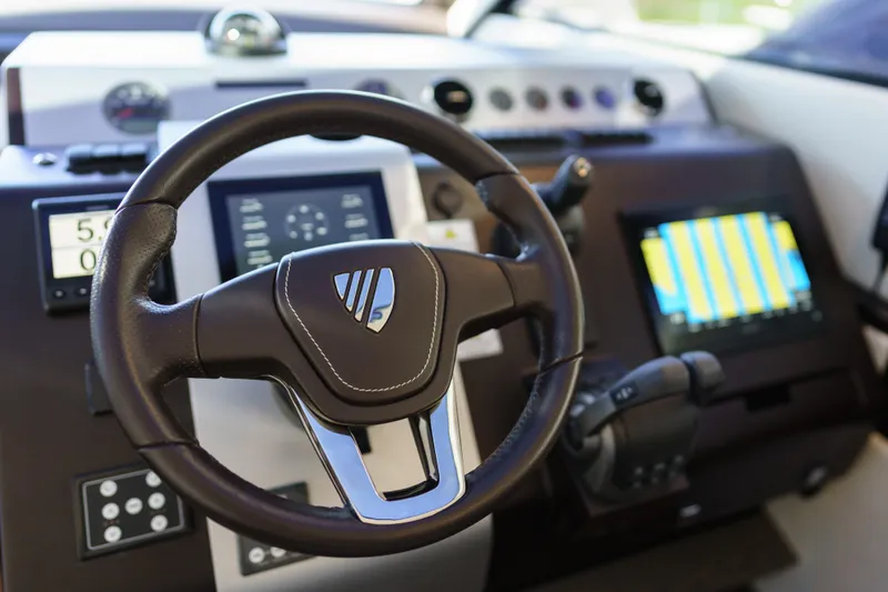  Yacht Photos Pics 2023 Fairline Targa 50 yacht helm with modern controls and navigation display.
