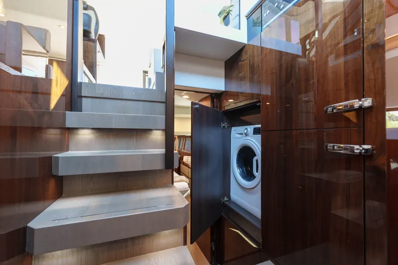  Yacht Photos Pics Interior of 2023 Fairline Targa 50 yacht with modern staircase and built-in washer.