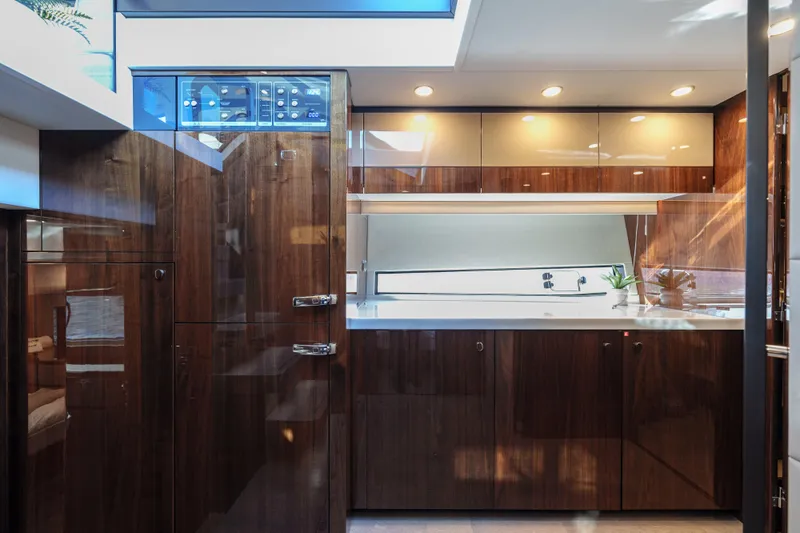  Yacht Photos Pics Luxurious 2023 Fairline Targa 50 yacht interior with sleek wood cabinetry and modern lighting.