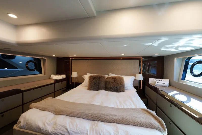  Yacht Photos Pics Luxurious 2023 Fairline Targa 50 yacht bedroom with elegant decor and plush bedding.