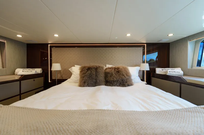  Yacht Photos Pics Luxurious bedroom interior of 2023 Fairline Targa 50 yacht with plush bedding.