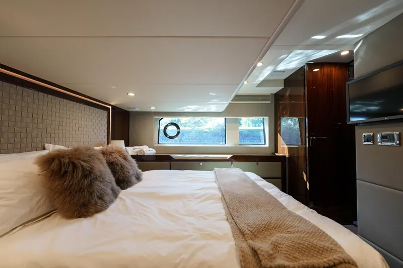  Yacht Photos Pics Luxurious bedroom interior of 2023 Fairline Targa 50 yacht, featuring elegant decor and modern amenities.