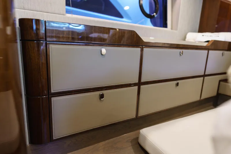  Yacht Photos Pics Luxurious interior cabinetry of 2023 Fairline Targa 50 yacht, featuring elegant wood and leather finishes.