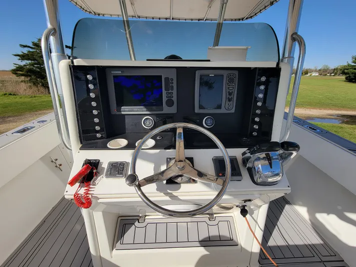  Yacht Photos Pics 1996 Venture 34 Center Console boat dashboard with steering wheel and navigation equipment.