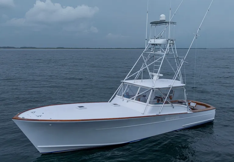  Yacht Photos Pics 2005 Gamefisherman 45 Express boat on calm ocean waters.
