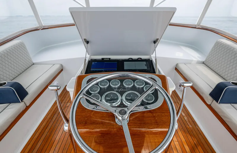  Yacht Photos Pics Helm of 2005 Gamefisherman 45 Express with wooden dashboard and seating.