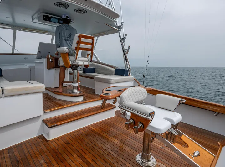  Yacht Photos Pics 2005 Gamefisherman 45 Express yacht with wooden deck, fishing chair, and ocean view.