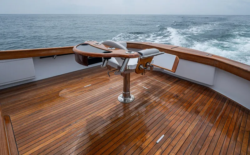  Yacht Photos Pics 2005 Gamefisherman 45 Express boat deck with wooden flooring and ocean view.