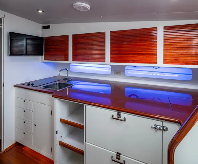  Yacht Photos Pics Interior of 2005 Gamefisherman 45 Express yacht with sleek kitchen and wooden cabinetry.