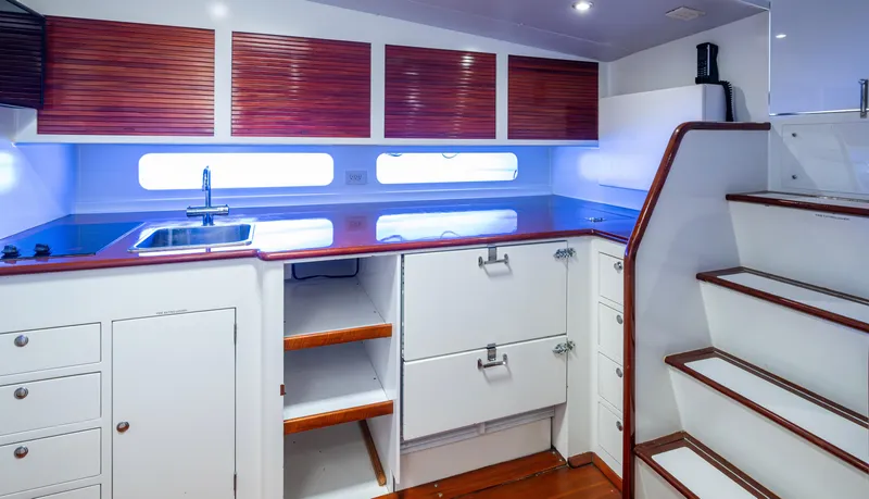  Yacht Photos Pics Luxurious 2005 Gamefisherman 45 Express yacht interior with modern kitchen and wooden cabinetry.