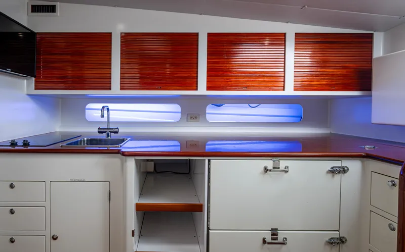  Yacht Photos Pics Luxurious 2005 Gamefisherman 45 Express yacht interior with sleek wooden cabinets and modern kitchen amenities.