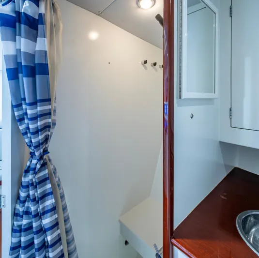  Yacht Photos Pics Interior of 2005 Gamefisherman 45 Express boat with striped curtain and sink.