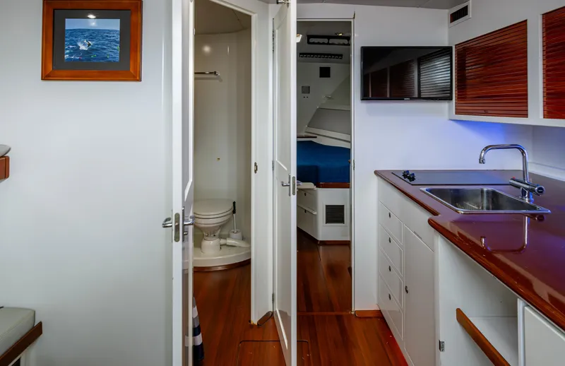  Yacht Photos Pics Interior of 2005 Gamefisherman 45 Express yacht, featuring a kitchenette and bathroom.