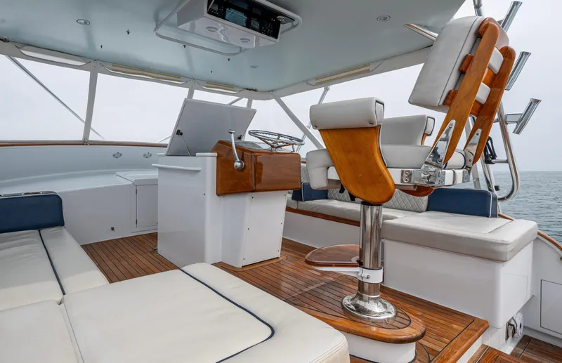  Yacht Photos Pics 2005 Gamefisherman 45 Express boat interior with helm, seating, and wooden accents.