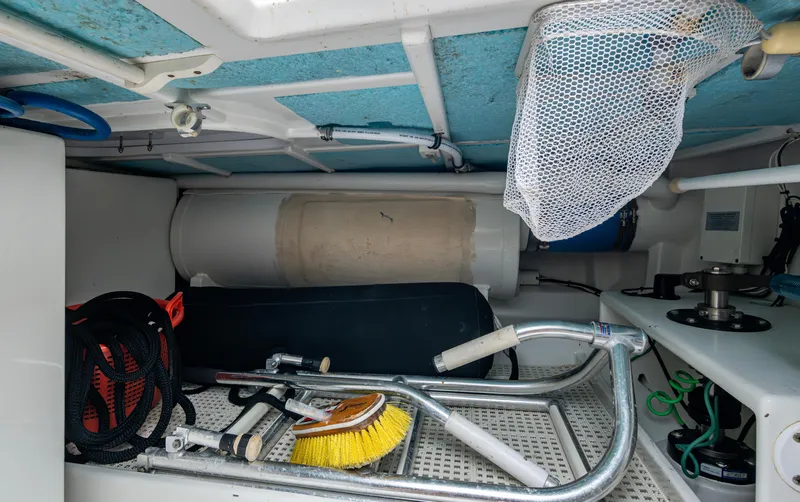  Yacht Photos Pics Storage compartment of 2005 Gamefisherman 45 Express with fishing gear and cleaning tools.