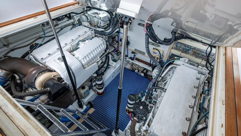  Yacht Photos Pics Engine room of 2005 Gamefisherman 45 Express boat, showcasing dual engines and mechanical components.