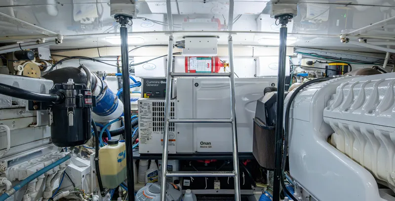  Yacht Photos Pics Engine room of 2005 Gamefisherman 45 Express, featuring Onan generator and various mechanical components.