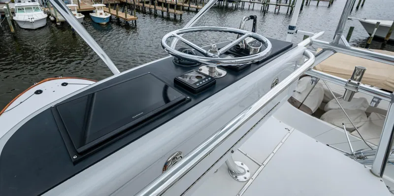  Yacht Photos Pics 2005 Gamefisherman 45 Express yacht helm with steering wheel and navigation equipment.