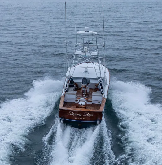  Yacht Photos Pics 2005 Gamefisherman 45 Express yacht cruising on open water, rear view.