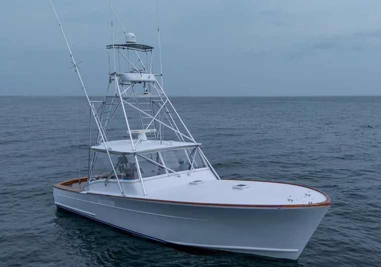  Yacht Photos Pics 2005 Gamefisherman 45 Express boat on open sea, featuring sleek design and fishing tower.