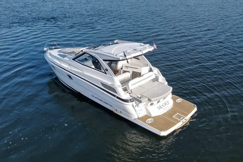  Yacht Photos Pics 2019 Regal 35 Sport Coupe boat on calm water, rear view.
