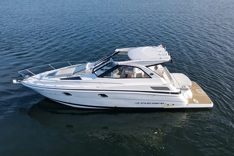  Yacht Photos Pics 2019 Regal 35 Sport Coupe boat cruising on open water.