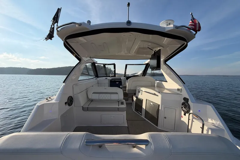  Yacht Photos Pics 2019 Regal 35 Sport Coupe boat interior with seating, cabinets, and open water view.