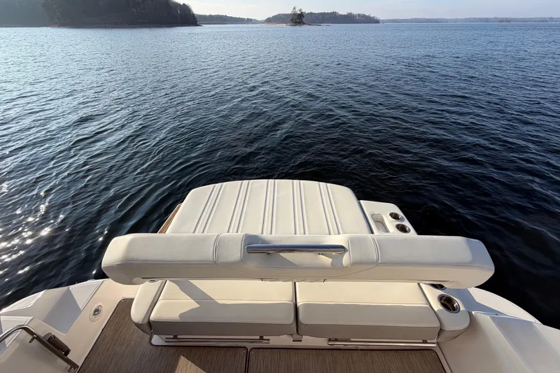  Yacht Photos Pics 2019 Regal 35 Sport Coupe boat with luxurious seating on a serene lake.