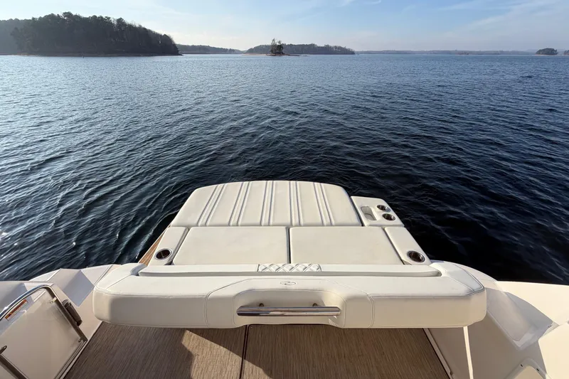  Yacht Photos Pics 2019 Regal 35 Sport Coupe boat with scenic lake view and swim platform.