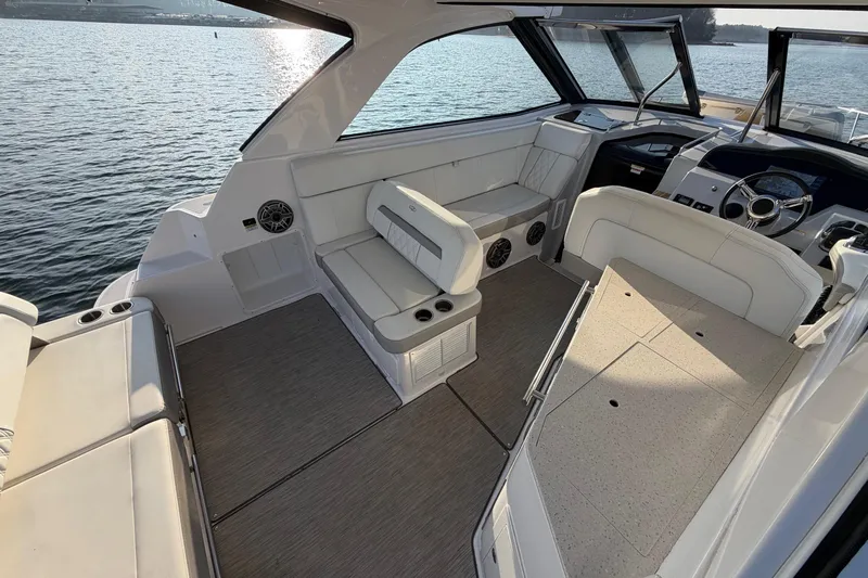  Yacht Photos Pics 2019 Regal 35 Sport Coupe interior with white seating and modern dashboard on the water.