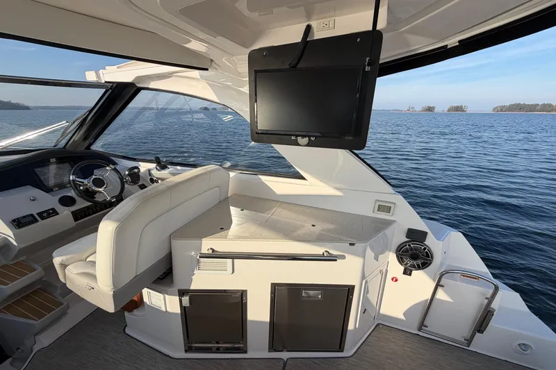  Yacht Photos Pics 2019 Regal 35 Sport Coupe interior with helm, seating, and ocean view.