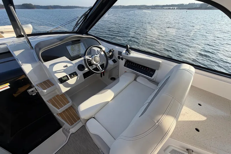  Yacht Photos Pics 2019 Regal 35 Sport Coupe helm with modern controls and scenic water view.