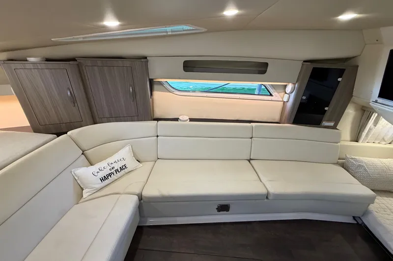  Yacht Photos Pics Luxurious interior of 2019 Regal 35 Sport Coupe with cream leather seating and wooden cabinets.