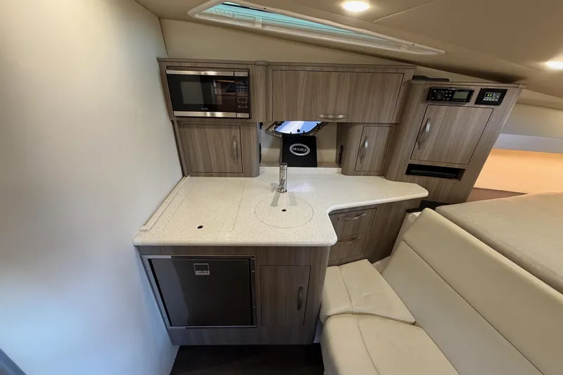  Yacht Photos Pics 2019 Regal 35 Sport Coupe interior kitchen with modern appliances and sleek cabinetry.