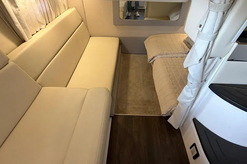  Yacht Photos Pics Interior of 2019 Regal 35 Sport Coupe with beige seating and cozy bed area.