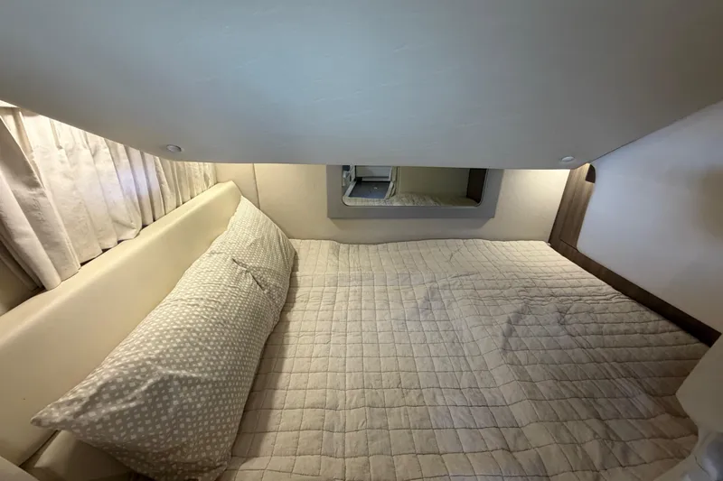  Yacht Photos Pics Cozy cabin bed in 2019 Regal 35 Sport Coupe with soft lighting and neutral decor.