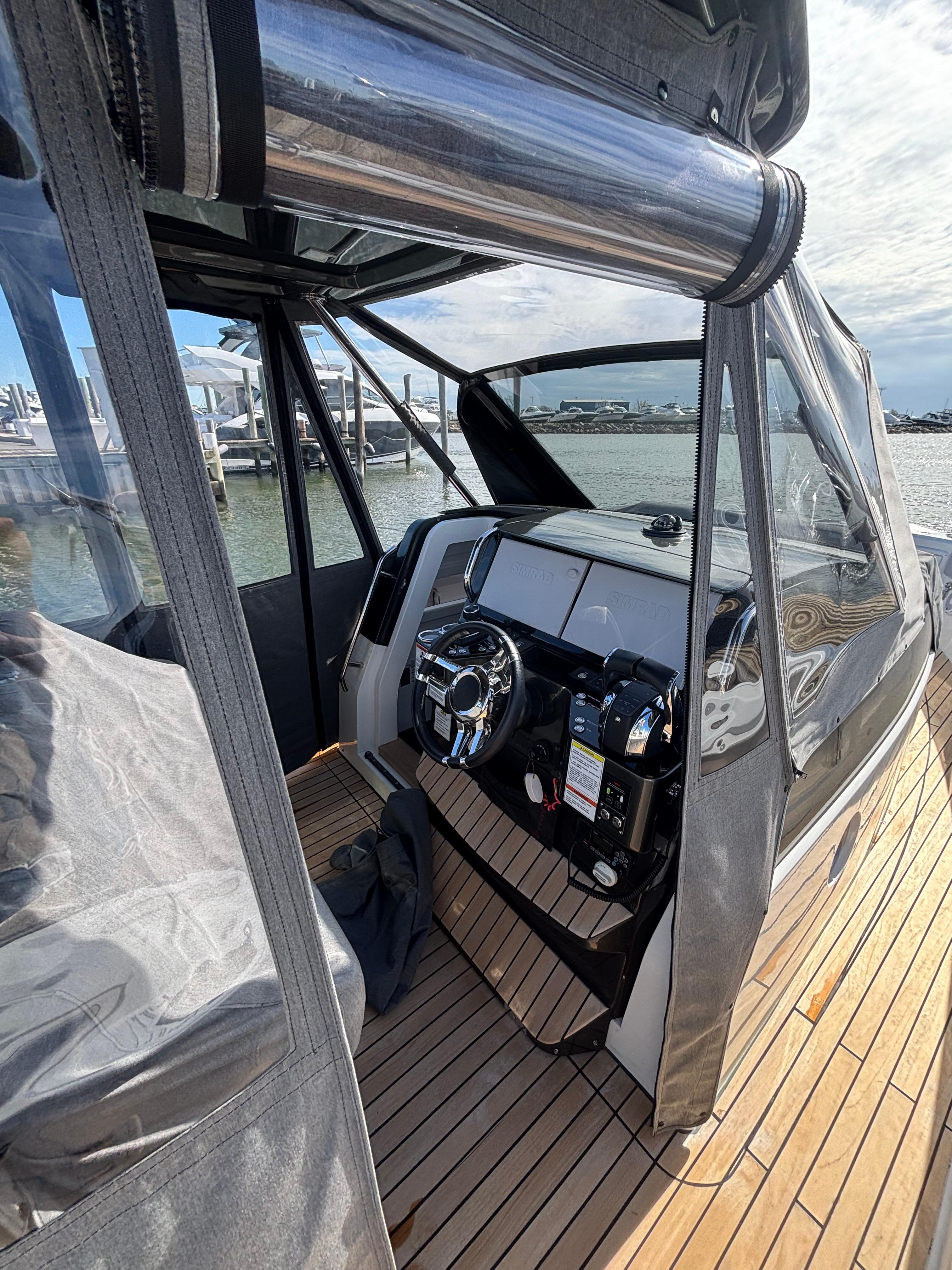 2023 Schaefer V33 boat interior with modern dashboard and wooden deck.