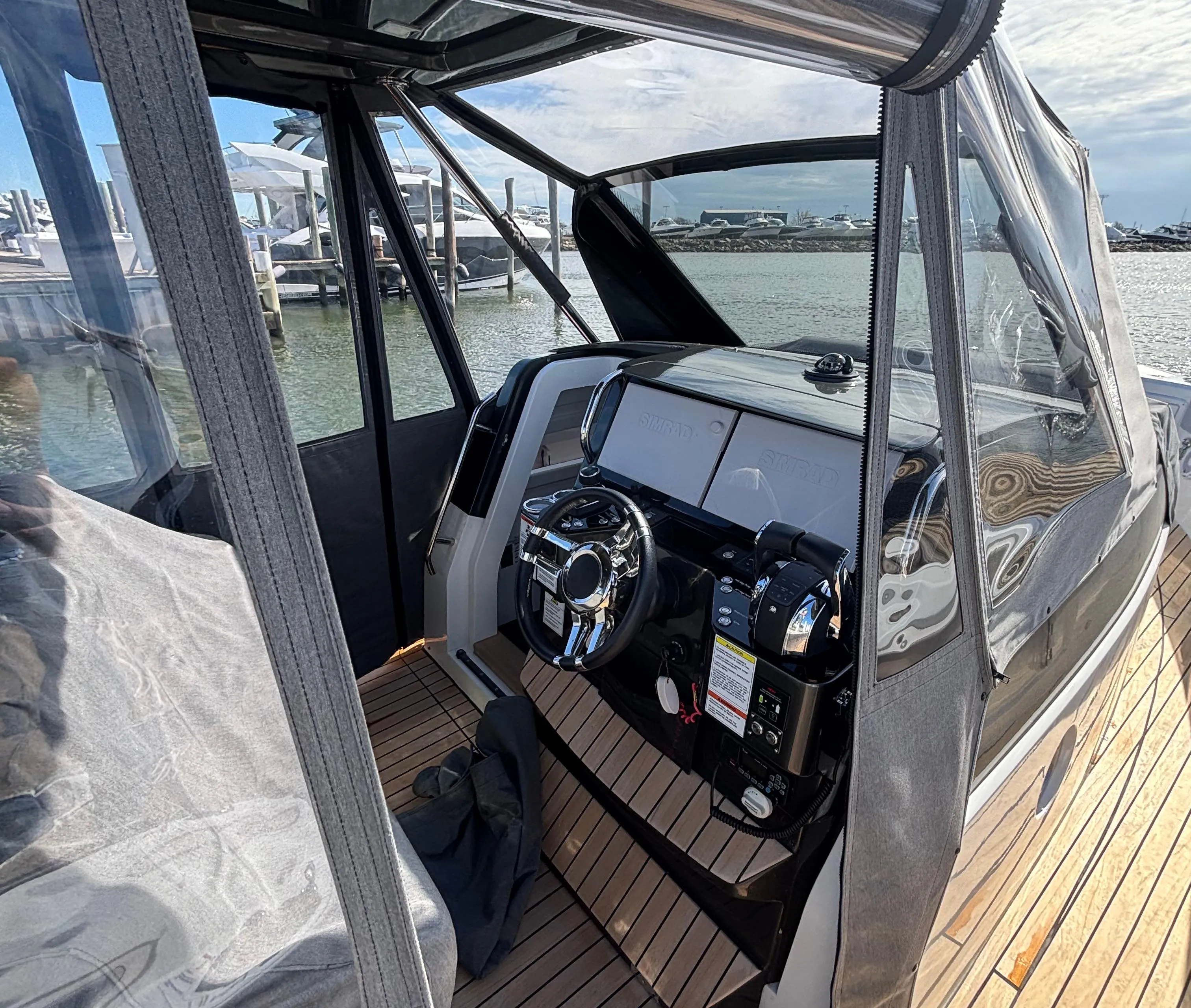 2023 Schaefer V33 boat interior with modern dashboard and wooden deck.