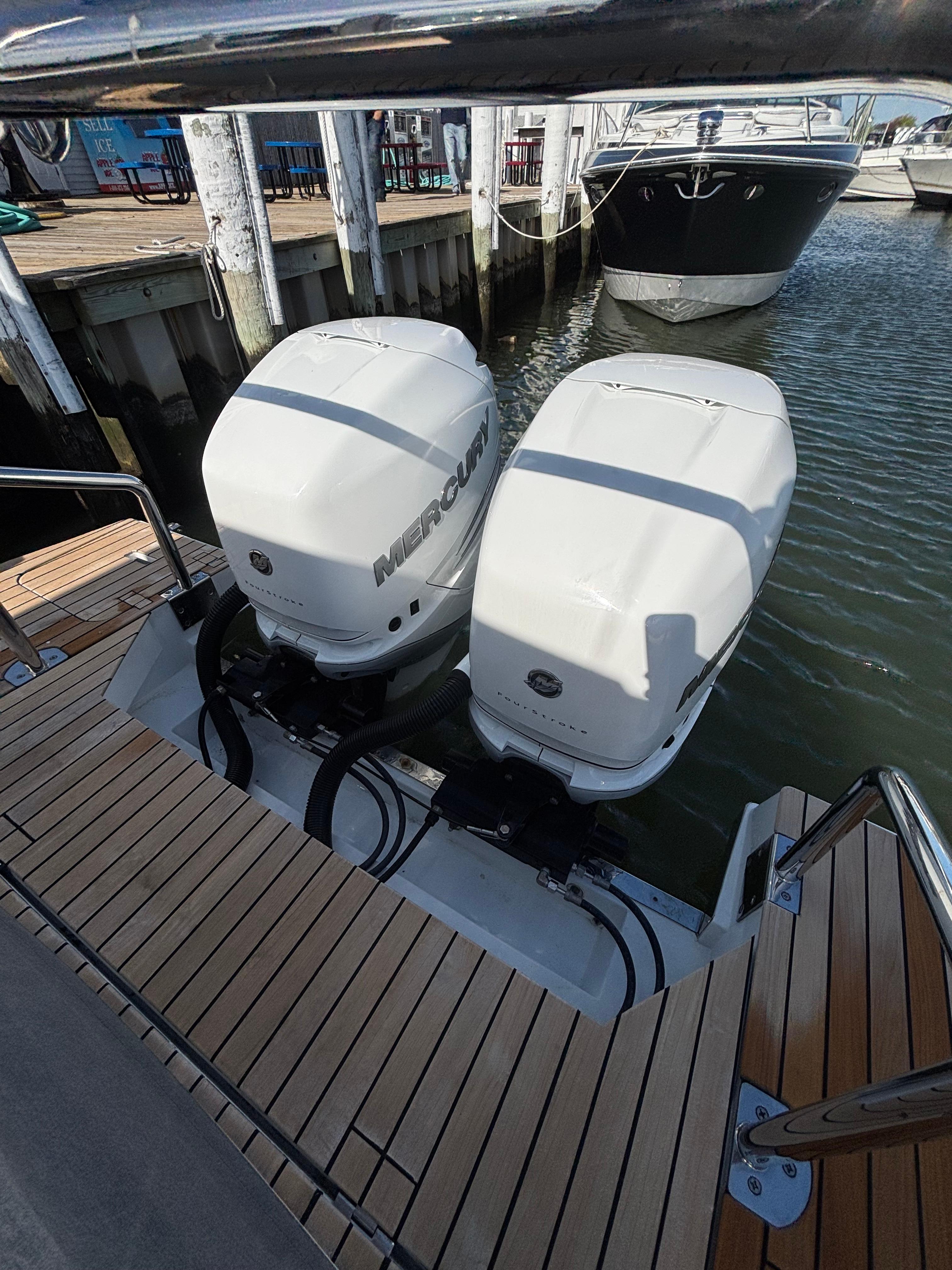 2023 Schaefer V33 boat with dual Mercury outboard engines docked at a marina.