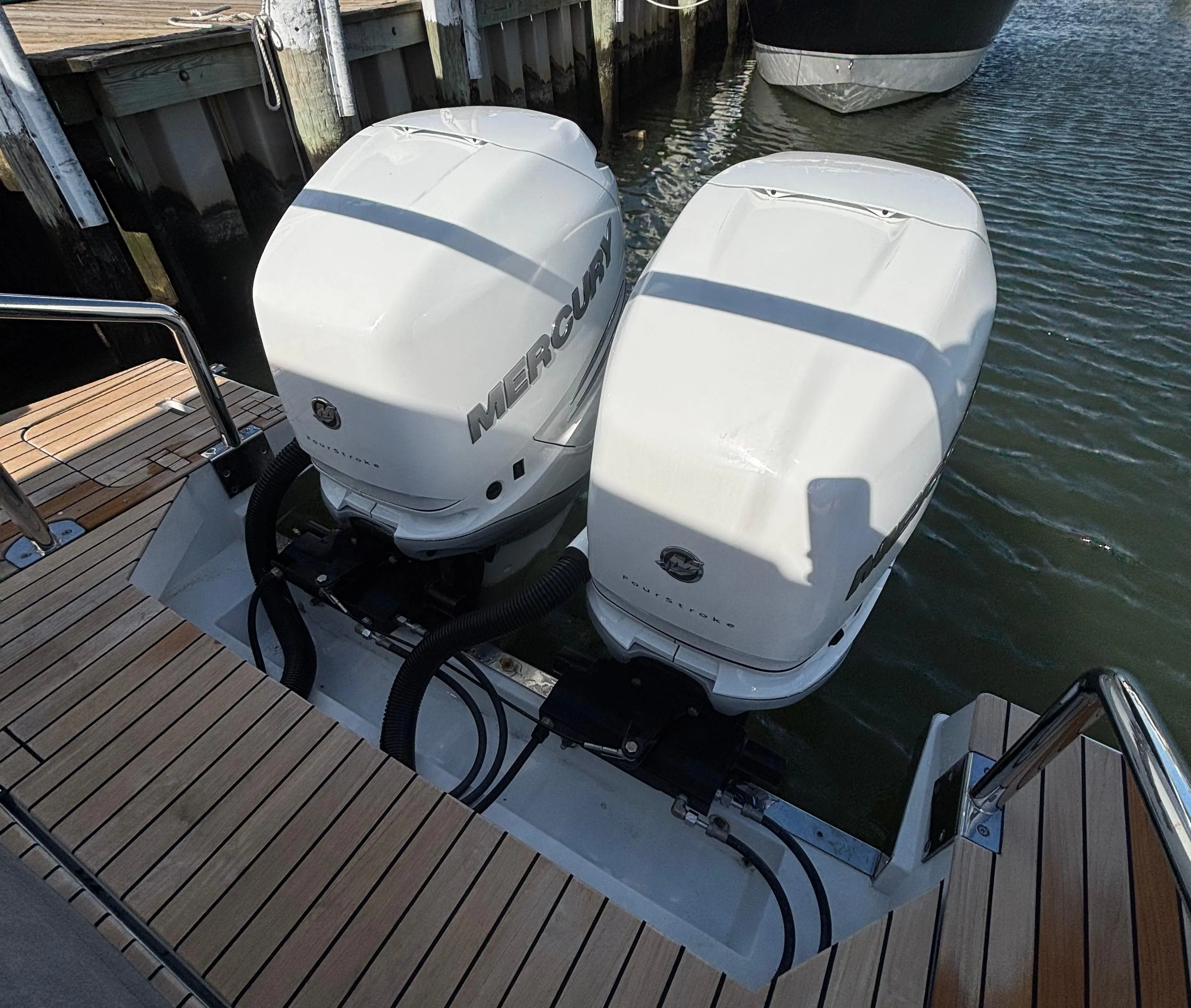 2023 Schaefer V33 boat with dual Mercury outboard engines docked at a marina.