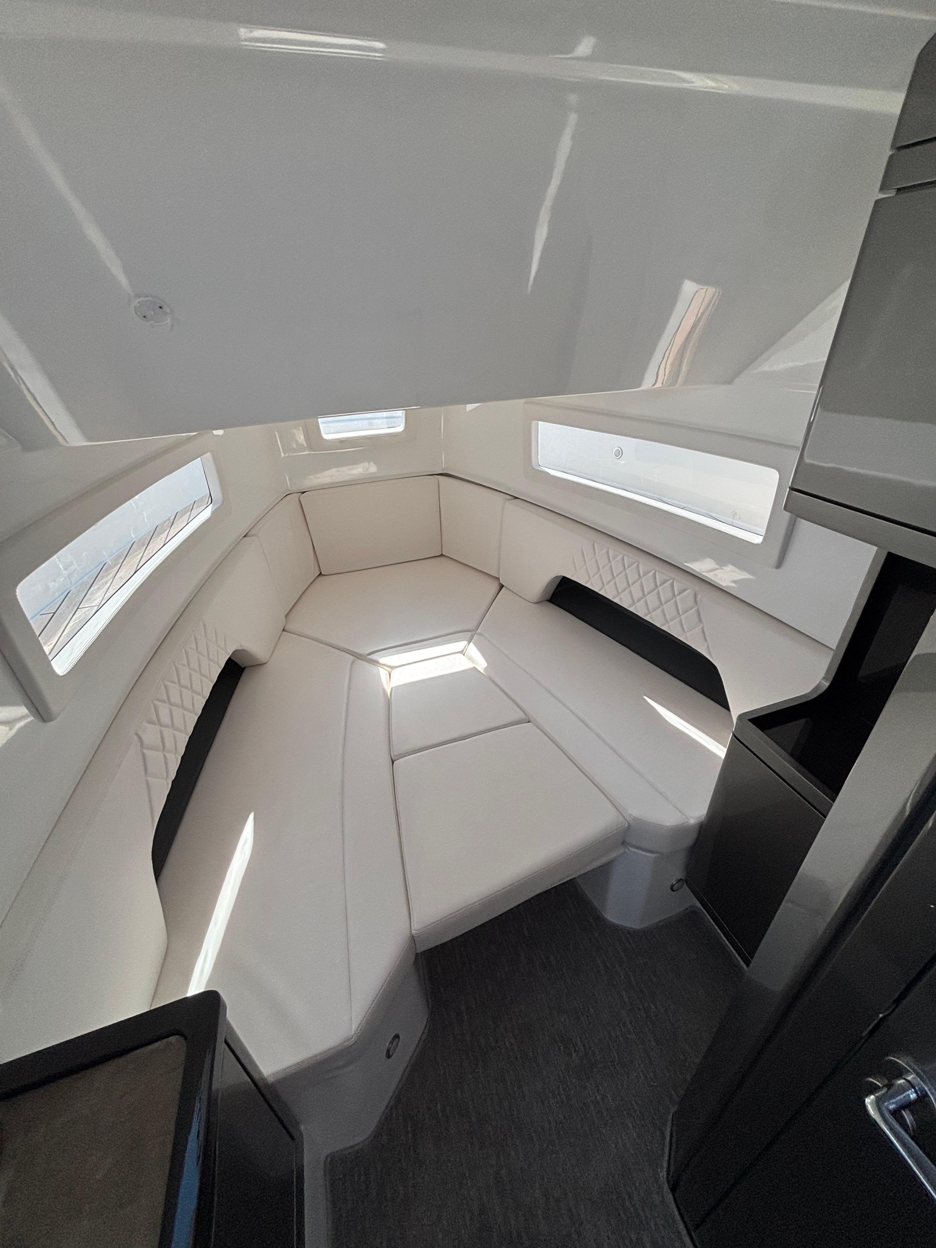 2023 Schaefer V33 boat interior with white seating and modern design.