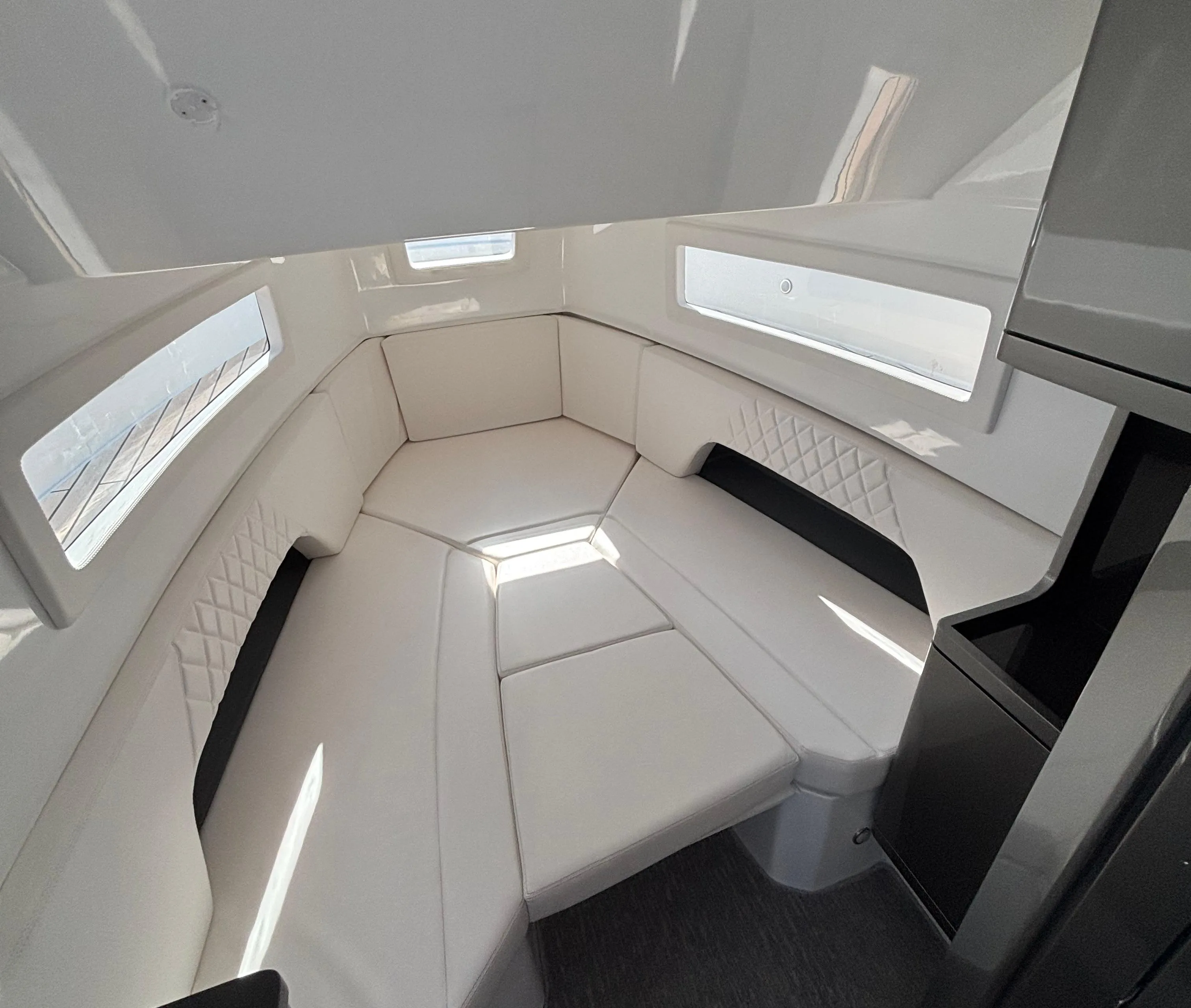 2023 Schaefer V33 boat interior with white seating and modern design.
