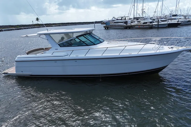  Yacht Photos Pics 2003 Tiara Yachts 4000 Express in marina, sleek design, calm waters, luxury boat.