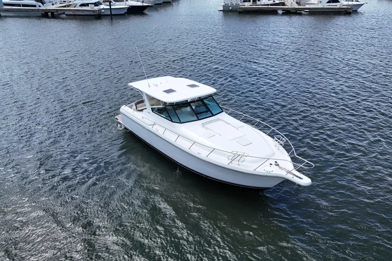  Yacht Photos Pics 2003 Tiara Yachts 4000 Express cruising on a calm marina waterway.