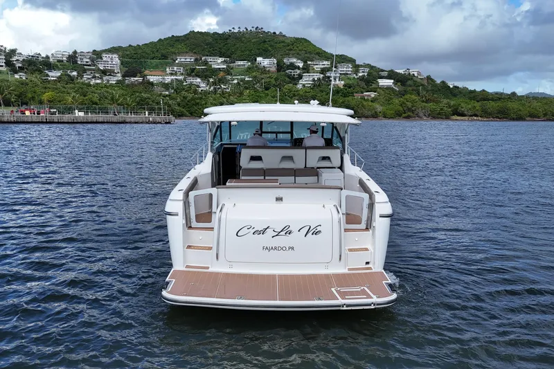  Yacht Photos Pics 2003 Tiara Yachts 4000 Express on water, scenic backdrop, "C'est La Vie" on stern.